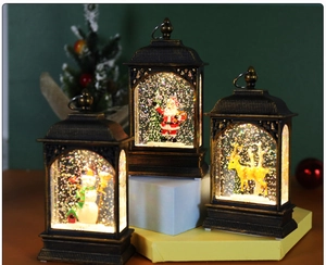 Close-up of lighted Christmas lantern with Santa, snowman and reindeer figures