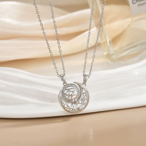 Close-up of silver-tone hollow moon and deer pendant with pavé zircon settings