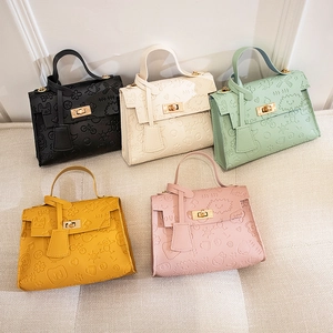 Mini Kelly crossbody bags in five colors with cute embossed cartoon patterns and metal locks
