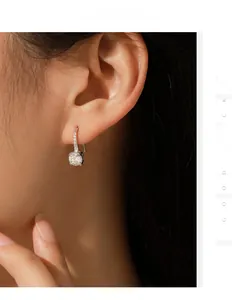 Close-up of elegant s925 silver 1ct moissanite hook earrings on female model