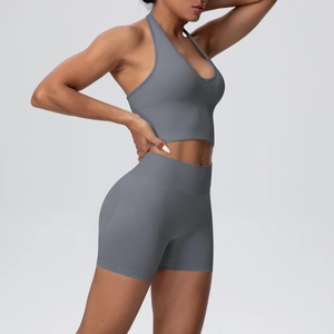 Side view of dark gray seamless knit yoga set featuring a halter bra and high-waist shorts