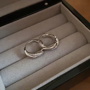 Minimalist silver double hoop earrings with pavé crystals for a sleek modern style