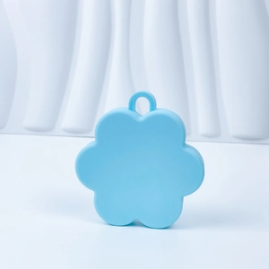 Detailed macro shot of the flower-shaped blue silicone scalp brush with flexible soft bristles
