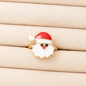 Detail of Santa Claus enamel ring with golden frame in a beige velvet jewelry box