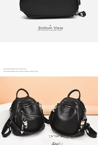 Detail view of black PU leather backpack with silver zippers and cute cow plush charm