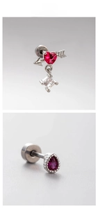 Macro detail of red heart and pear-cut zircon earrings with silver steel finish