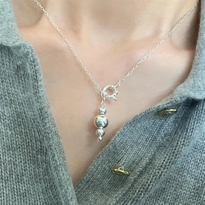 Minimalist 925 sterling silver necklace with three polished silver beads on female model