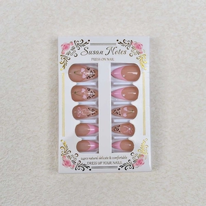 Press on nails with pink French tips, leopard print, cherry design, and pearls in 24pc set