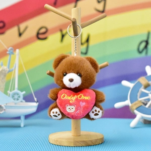 Close-up of a brown plush bear keychain holding a red heart with Only One embroidery