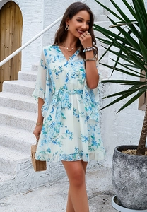 Detail view of blue floral chiffon dress with V-neckline and ruffled hemline