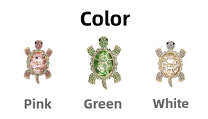 Detailed view of three vintage alloy turtle brooches with pink, green and white crystals