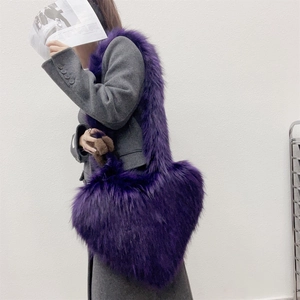 Fashionable purple faux fur heart-shaped crossbody bag shown on a model