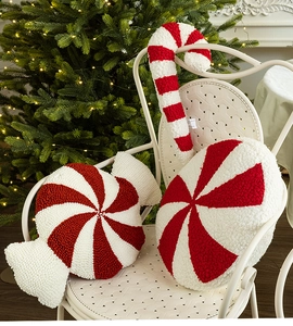 Detail of red and white candy cane pillows in soft sherpa fabric for Christmas decor