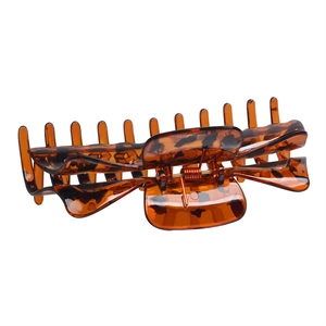 Macro shot of large amber tortoise shell hair claw clip with strong metal spring