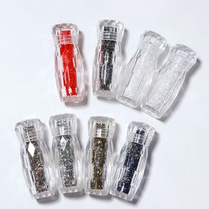 Eight colors of iridescent nail art micro beads in diamond-cut bottles on white background