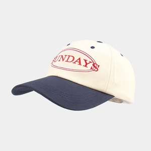 Detail of navy blue brim and beige crown with Sundays Running Club embroidery