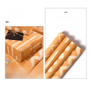 Macro view of kraft gift wrapping paper rolls with white polka dot and stripe patterns