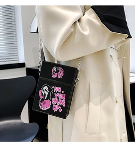 Ghostface Scream bag with pink chain strap worn over a classic beige trench coat