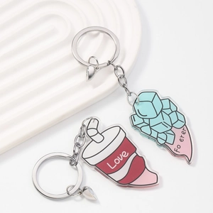Detail of acrylic couple keychains with magnet love cup and blue ice cube shapes