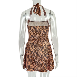 Detail of backless halter dress showing vibrant floral print and elegant tie neck closure