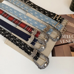Detail of vintage American style star cutout belts with large engraved metal buckles