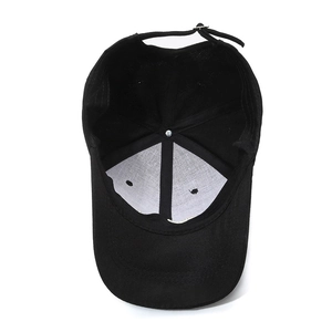 Inside view of adjustable black cotton baseball cap showing internal lining and metal buckle