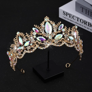Macro view of gold bridal tiara with colorful marquise crystals and classic leaf patterns