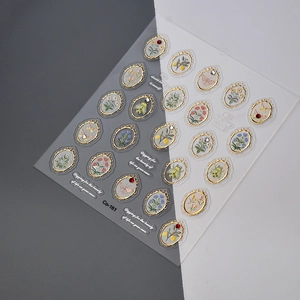 Macro detail of 3D embossed nail art stickers with vintage gold frames and floral motifs