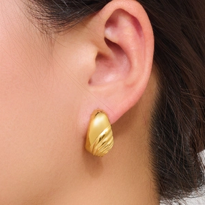 Minimalist golden wavy shell-textured stainless steel hoop earrings shown on ear