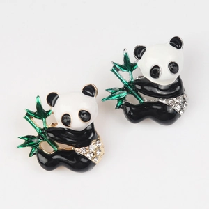 Close-up of enamel panda brooches with green bamboo and sparkling crystal accents