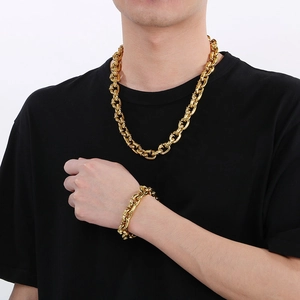 Chunky gold stainless steel square nail necklace and bracelet set worn by a model