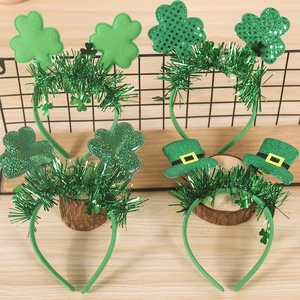 Detail view of four St. Patrick's Day headbands with shamrocks and green hats on wood