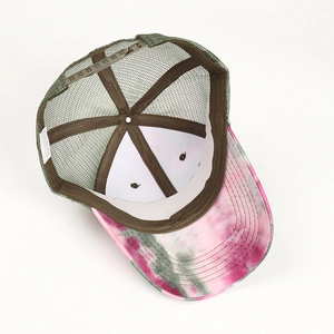 Close-up of tie-dye trucker hat showing mesh back, plastic snapback, and inner stitching