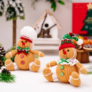 Detail of gingerbread man plush figures with knitted texture and festive accessories