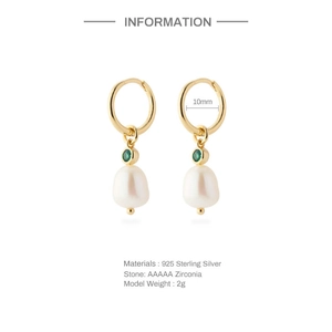 Detail of 925 sterling silver gold earrings featuring green zircon and white pearl charms