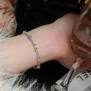 Close-up of elegant silver bracelet with heart-shaped cubic zirconia on a wrist