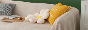 Nordic beige textured sofa cover styled with yellow Hello Sunshine and floral pillows
