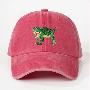 Detailed close-up of green dinosaur embroidery on vintage red washed cotton baseball cap
