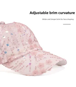 Detailed side view of pink mesh baseball cap with floral sequins and wide curved brim