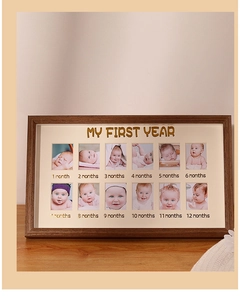 Detail of baby first year photo frame with twelve monthly slots and gold lettering