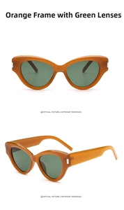 Detail of vintage cat-eye sunglasses with orange frames, green lenses, and silver metal accents