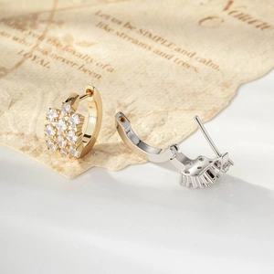 Vintage style gold and silver square cz hoop earrings on a decorative letter background