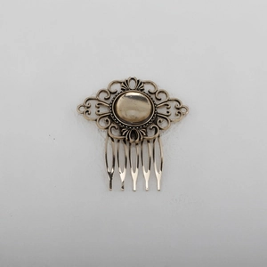 Macro view of vintage bronze leaf hair comb featuring intricate floral openwork pattern