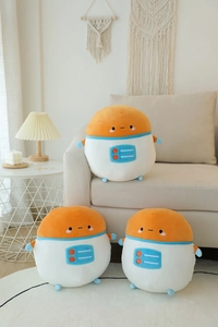 Detail of three soft cartoon astronaut plush toys on a sofa in a warm home setting