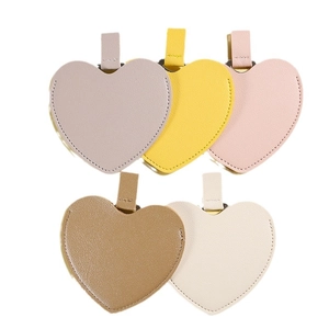 Irregular heart-shaped PU leather portable makeup mirrors in multiple pastel colors