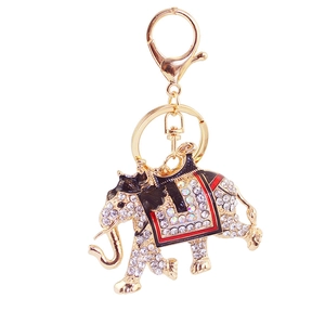 Detailed close-up of golden elephant keychain with sparkling rhinestones and enamel accents