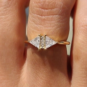 Minimalist gold triangle ring with micro-pawned zircons worn on finger for daily style