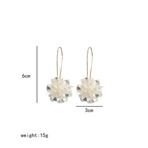 Detail of white shell flower earrings showing 6cm height and 3cm width dimensions