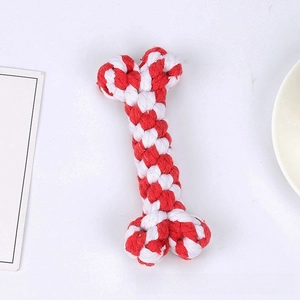 Macro shot of red and white braided cotton rope dog toy in a durable bone shape