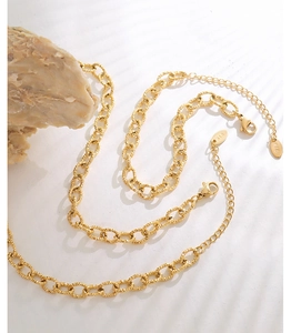 Macro shot of 18K gold plated thick chain jewelry with lobster clasp and K18 tag